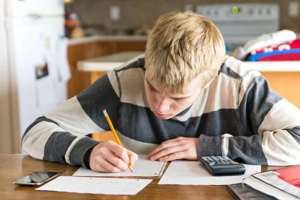 A male student working on his math homework